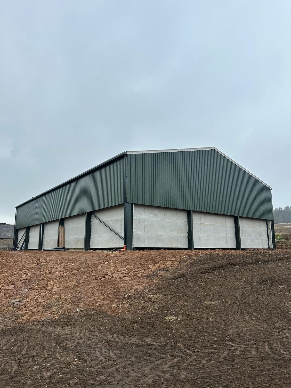 Completed agricultural building with green cladding, rear view