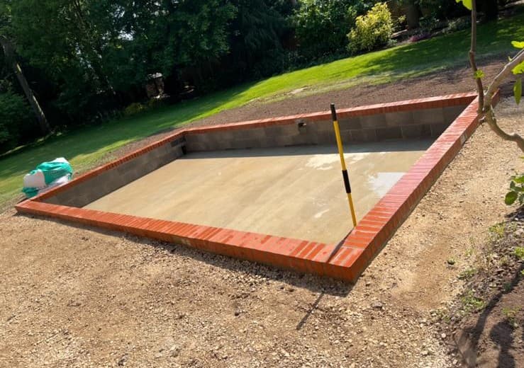 Concrete base with brick edging in garden
