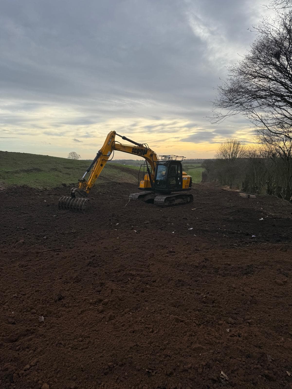Excavator groundworks at sunset