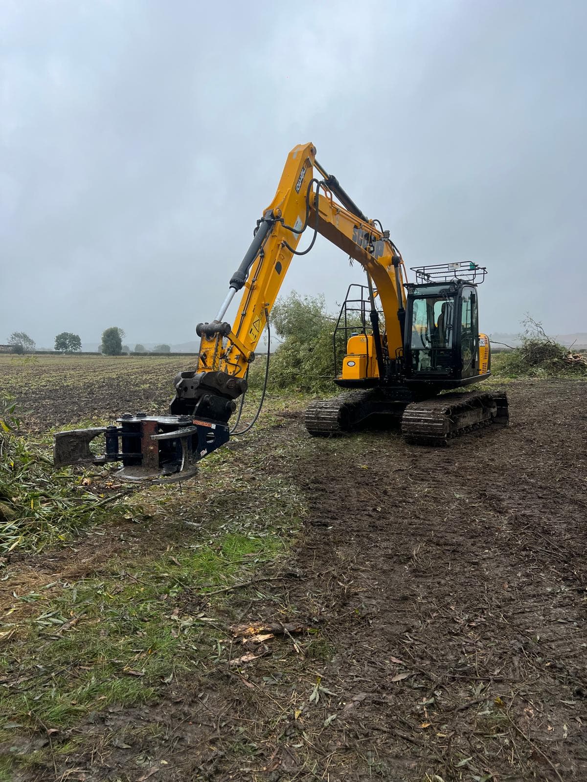 Excavator with rotary attachment for hedge clearance