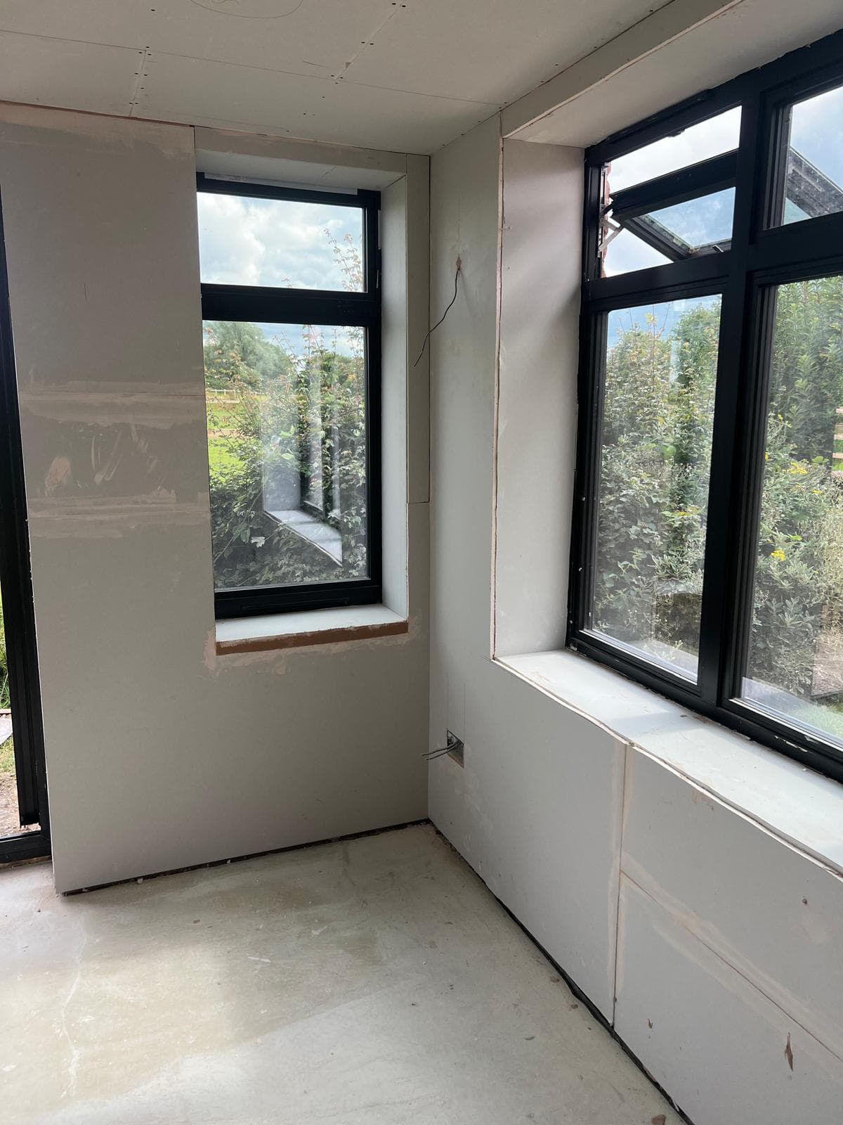 Extension interior with plasterboard and windows fitted