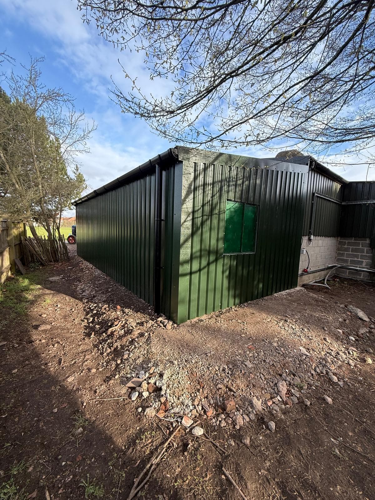 Angled view of green steel clad agricultural building