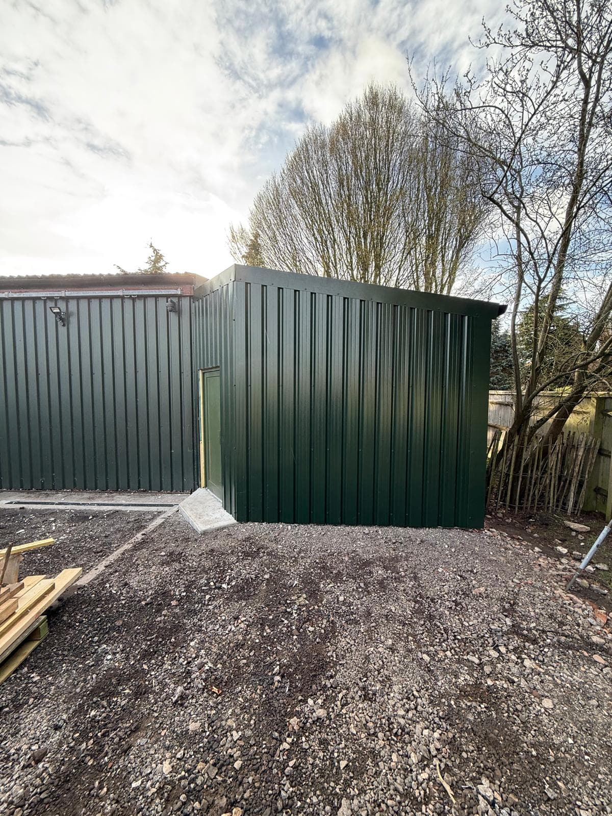 Small agricultural building with green steel cladding