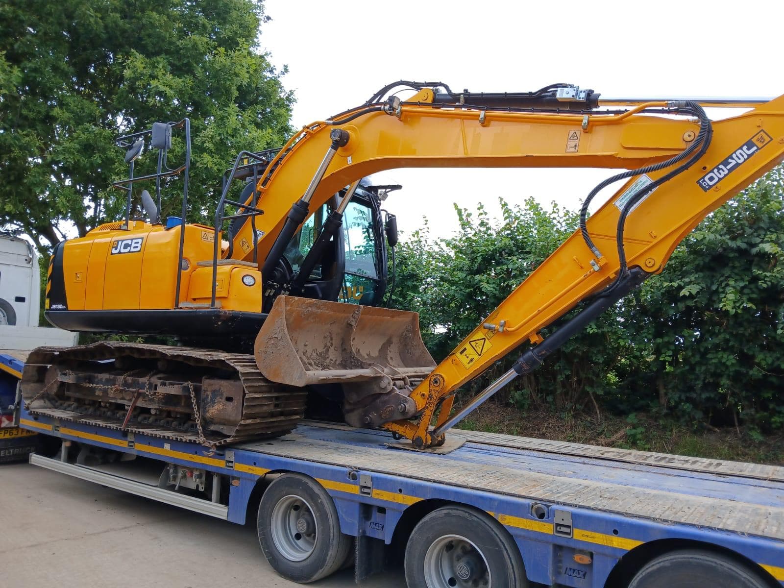 JCB excavator loaded on a low loader