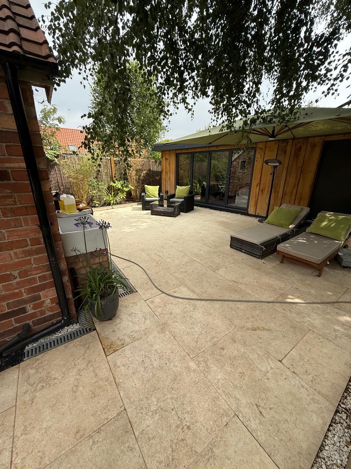 Porcelain tiled patio alongside a garden room