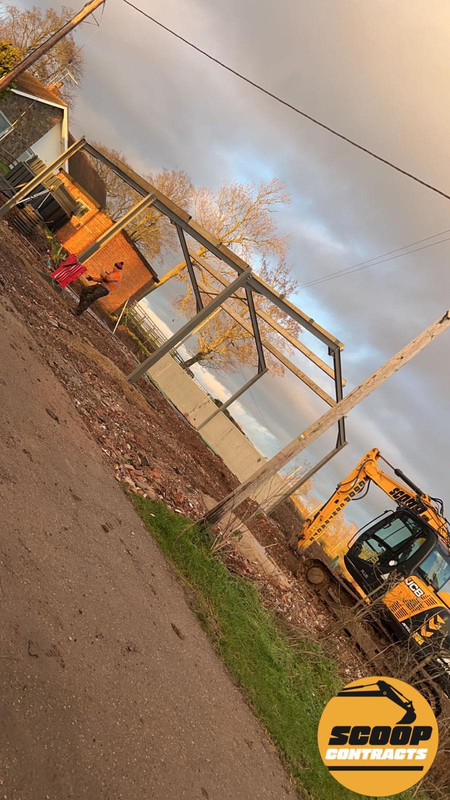 Steel portal frame construction with excavator on site