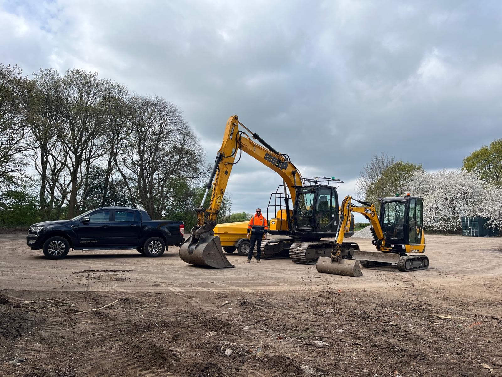 Scoop Contracts team, excavators and pickup truck