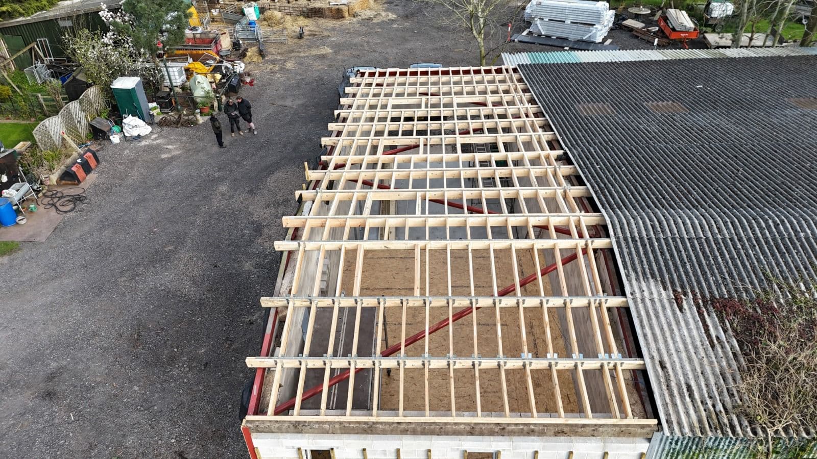 Team on timber frame flat roof, drone shot