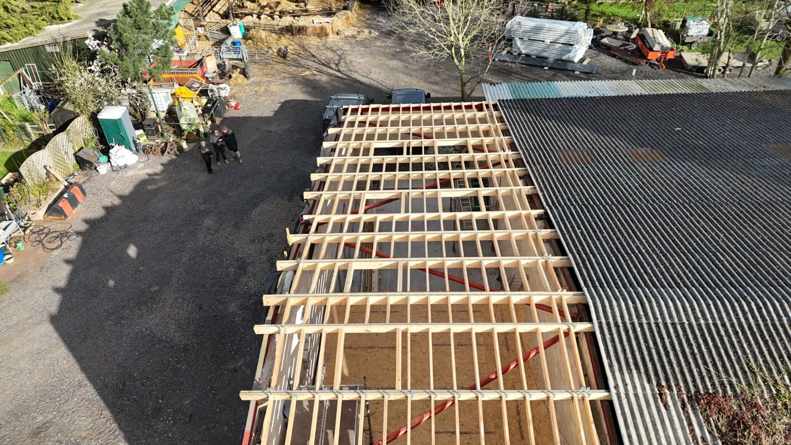 Workers on timber frame flat roof, aerial view